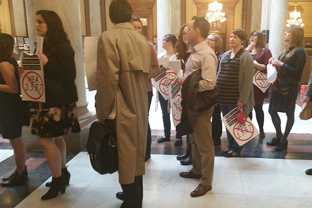 Opponents to HEA 1337 file in to Indiana Governor Mike Pence's office to deliver nearly 2700 signatures asking him to veto the legislation. (Photo: Indy Feminists)