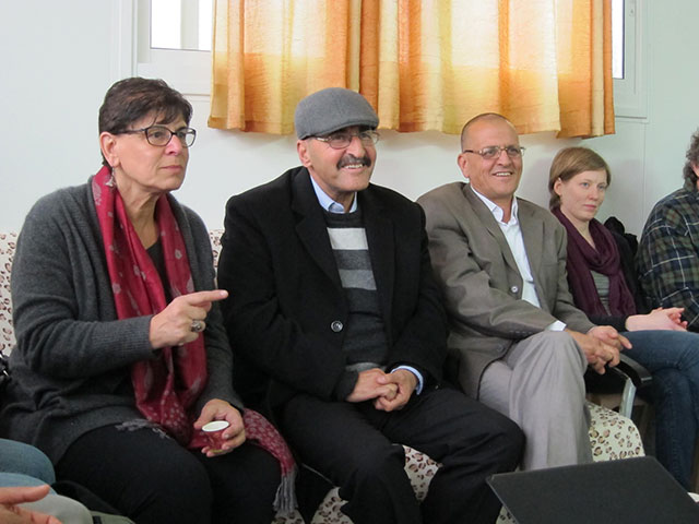 Muhammad Allyan, second from left, sits with family and delegation members in a house next to his demolished home. Far left, Rabab Abdulhadi, translator. (Photo: Susan Chen)