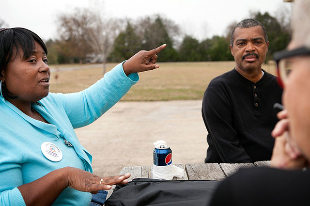 Esther Calhoun speaks with her friends Ben Eaton and Barbara Evans in Uniontown, Alabama. The operators of a nearby landfill recently sued Calhoun, Eaton and two other activists from a local community group for posting statements criticizing the landfill on Facebook. The activists organized to challenge the landfill after it accepted a massive amount of toxic coal ash from an environmental disaster in Tennessee. 