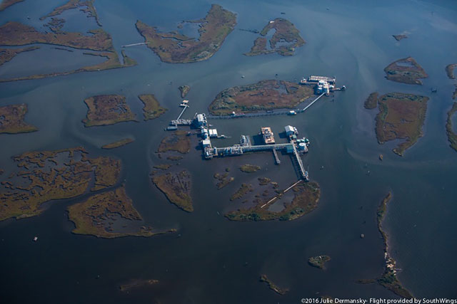 Infrastructure dots the waters and disappearing coastal land of Plaquemines Parish. (Photo: Julie Dermansky)