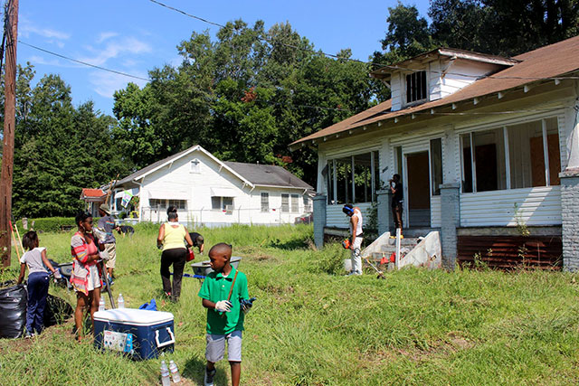 The Green Team Cooperative (focused on landscaping, composting and recycling) clean out a vacant house that was acquired by Cooperation Jackson for the development of its Community Land Trust. (Photo: Courtesy of Kali Akuno / Cooperation Jackson)