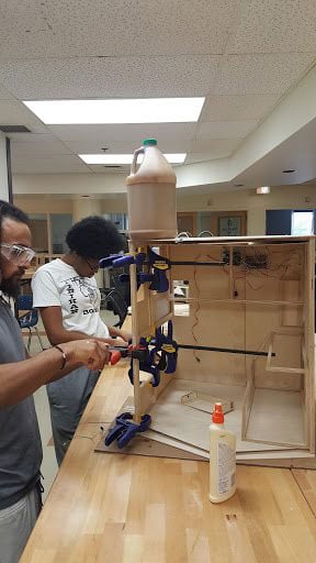 Members of Cooperation Jackson's community production team work on a digitally fabricated model of a tiny house that the team is designing. (Photo: Courtesy of Kali Akuno / Cooperation Jackson)