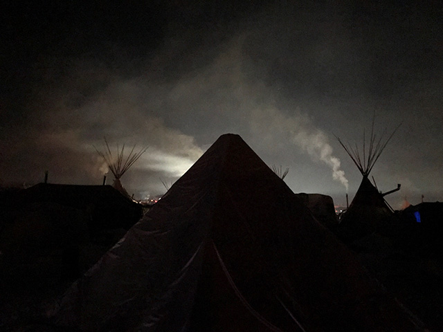 Fires burn at the Oceti Sakowin Camp to warm Water Protectors through the harsh night. (Photo: Human Pictures and Other Worlds)