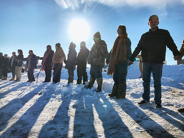 Water Protectors join their hands together in unity and resistance. (Photo: Human Pictures and Other Worlds)