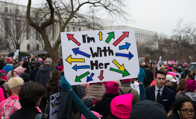 One of the hundreds of thousands that took to the nations capitol holds a home made sign that plays on Hillary's campaign slogan I'm with her. (Photo: Zach Roberts)