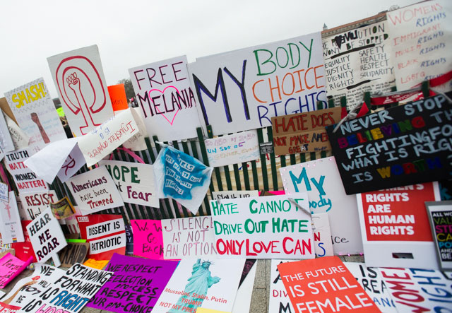 As the marches left Washington DC many left behind their homemade signs on a fence that crossed the White House lawn. (Photo: Zach Roberts) 