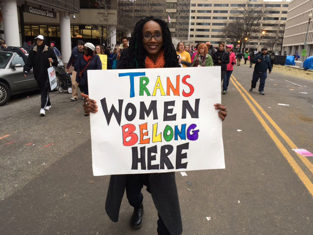 A protester on C Street reminds trans women that they are welcome at the march in Washington, DC. (Photo: Rebekah Frumkin)