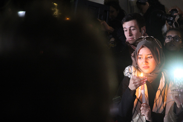 Thania Hussain holds a candle as speakers address the crowd assembled in Washington Square Park. (Photo: John Knefel)
