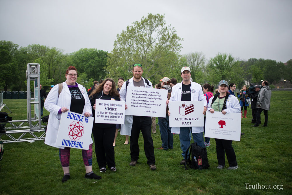 A group of friends cosplaying as scientists march with their friend, Tom Healey [center] who actually is a scientist. (Photo: Zach Roberts) 