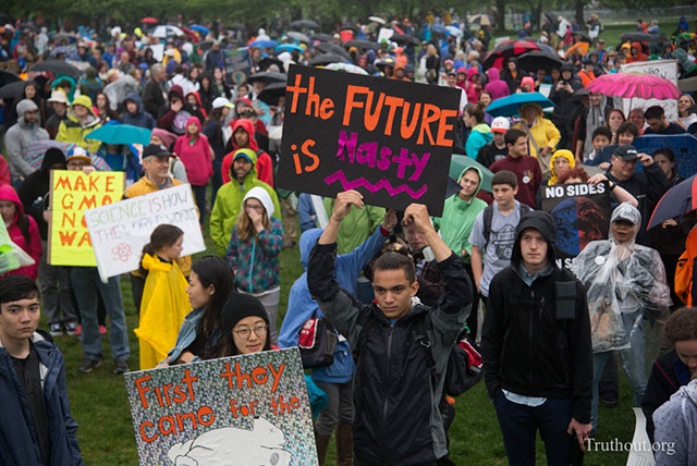 A man in the audience at the DC Science March holds up a sign that references President Trump calling Secretary Clinton a nasty woman. (Photo: Zach Roberts)