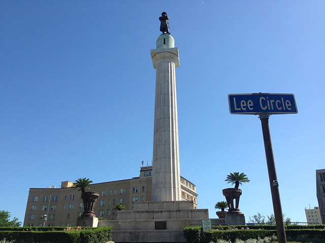A statue of the Confederate General Robert E. Lee sits atop a large  monument at the center of Lee Circle in the Central Business District of New  Orleans, Louisiana. The monument is one of four being removed after years of  protest by racial justice activists. (Photo: Mike Ludwig)