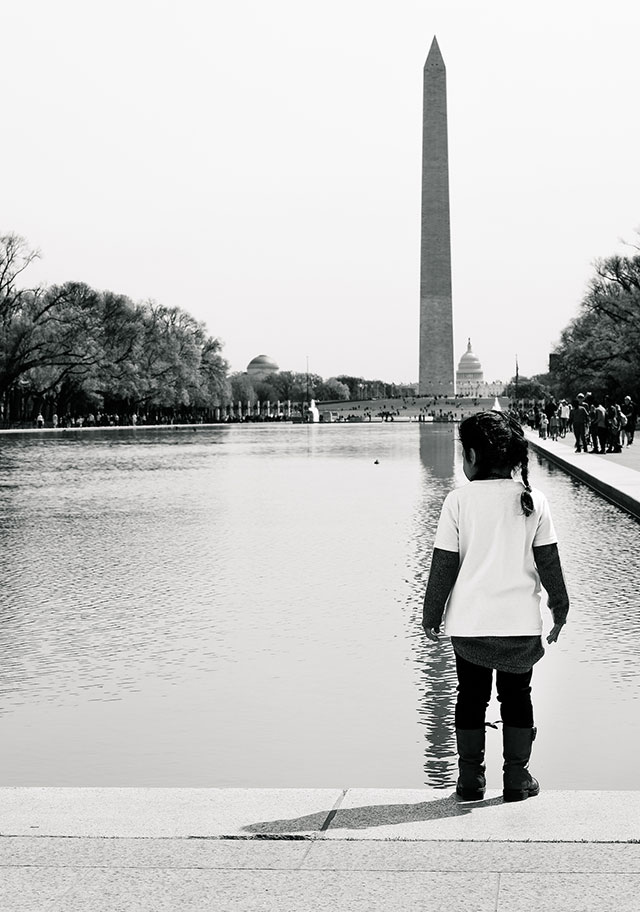 Washington, DC, April 13, 2017: A child of immigrant parents, who joined the We Belong Together Kids Caravan, stands at the reflecting pool between the Lincoln Memorial and Washington Monument. (Photo: Steve Pavey) 