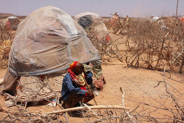 An old man squatting outside his shelter in an IDP settlement in the region around Gode. (Photo: James Jeffrey / IPS)