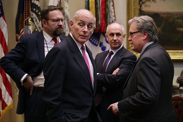 (2nd L-R) Homeland Security Secretary John Kelly, White House Director of Strategic Initiatives Chris Liddell and Chief Strategist Steve Bannon wait for the arrival of President Donald Trump before a meeting about cyber security in the Roosevelt Room at the White House January 31, 2017 in Washington, DC. (Photo: Chip Somodevilla / Getty Images)