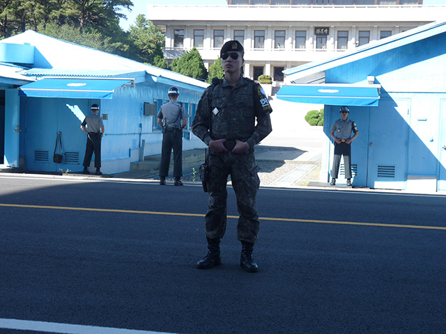 South Korean Army personnel stand guard at the Demilitarized Zone/Joint Security Area outside the Military Armistice Commission buildings along the tense border. (Photo: Jon Letman)