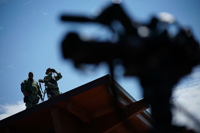 Police with binoculars and a rifle position themselves on a roof across the street from the Charlottesville City Hall before Jason Kessler, an organizer of 'Unite the Right' rally, tried to speak outside the Charlottesville City Hall on August 13, 2017 in Charlottesville, Virginia. The police often stood by as white supremacists escalated violence against anti-racist counter-protesters. (Photo: Win McNamee / Getty Images)