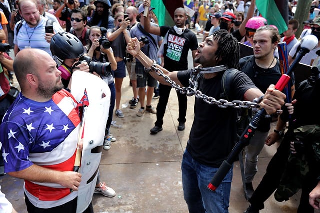 White nationalists and neo-Nazis exchange insults with anti-racist counter-protesters as they attempt to guard the entrance to Emancipation Park during the 'Unite the Right' rally August 12, 2017, in Charlottesville, Virginia. (Photo: Chip Somodevilla / Getty Images)