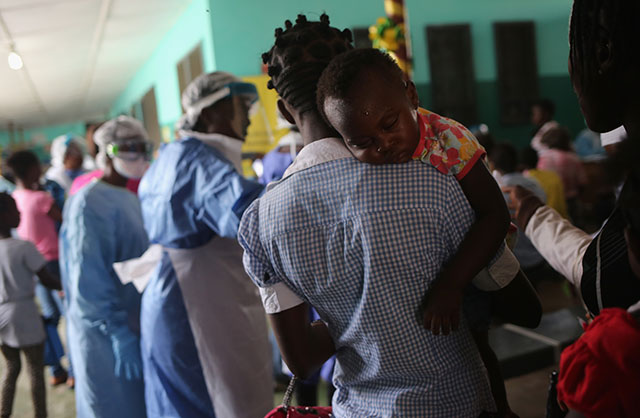 People await treatment in the outpatient lounge of Redemption Hospital, formerly an Ebola holding center, on February 2, 2015 in Monrovia, Liberia. Many Americans suffer from the same lack of access to facilities and affordable drugs as patients in Liberia — yet the US spends more on health care than any other country in the world. (Photo: John Moore / Getty Images)