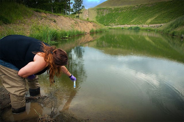 April Jarocki, a resident in Tennessee's Cumberland Mountains, tests water on May 18, 2017 for any pollutant that might have come coal mining activity. (Photo: Valerie Vozza for Equal Voice News)