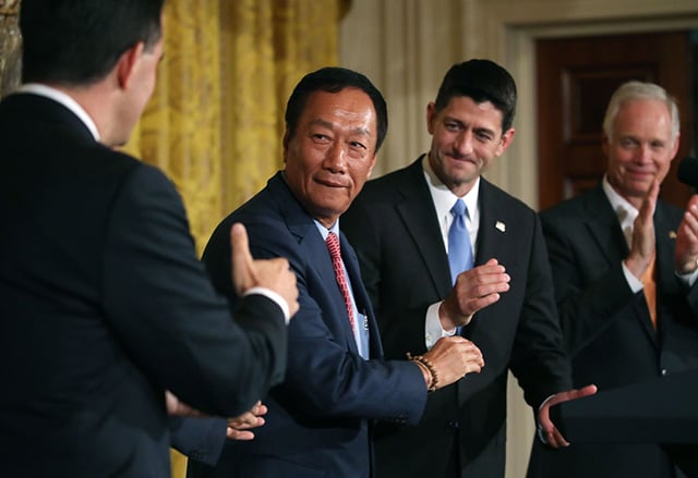 Terry Gou (2nd left), chairman of Apple supplier Foxconn, shakes hands with Wisconsin Gov. Scott Walker (right) as House Speaker Paul Ryan looks on at news conference held by U.S. President Donald Trump in the East Room of the White House July 26, 2017 in Washington, DC. (Photo: Mark Wilson / Getty Images)