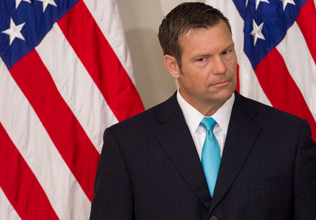 Kansas Secretary of State Kris Kobach listens as Donald Trump speaks during the first meeting of the now-defunct Presidential Advisory Commission on Election Integrity in the Eisenhower Executive Office Building next to the White House in Washington, DC, July 19, 2017. (Photo: SAUL LOEB / AFP / Getty Images)