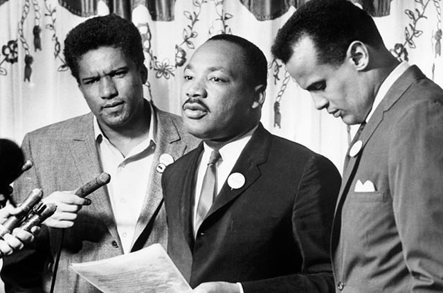 Integration leader, Dr. Martin Luther King, Jr. (center) and the James Forman of SNCC (left), announced at a news conference that their respective organizations would begin working together on civil rights projects. Singer Harry Belafonte (right), presided over the meetings that brought the two leaders together. (Photo: Bettmann / Contributor / Getty Images)