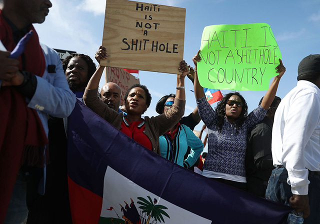 People join together, near the Mar-a-Lago resort where Donald Trump spent the last few days, to condemn Trumps statement about immigrants from Haiti and to ask that he apologize to them on January 15, 2018, in West Palm Beach, Florida. Trump is reported to have called Haiti, Africa and El Salvador places 