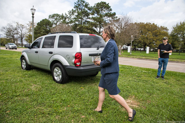 Anne Rolfes, founder of the Louisiana Bucket Brigade, trying to figure out who was in an SUV monitoring the press conference across from the Governor’s Mansion. (Photo: © Julie Dermansky)