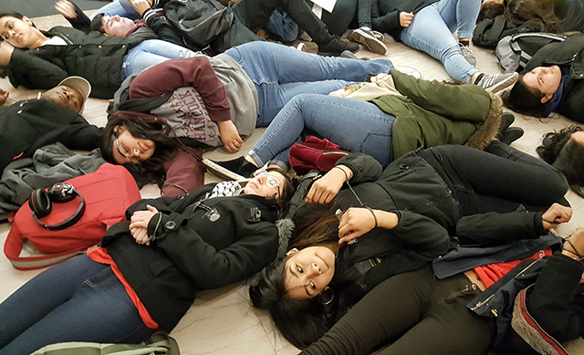 Chicago students stage a die-in at City Hall with their hands bound in mock zip ties to illustrate the criminalization they experience, in addition to gun violence. (Photo: Kelly Hayes)