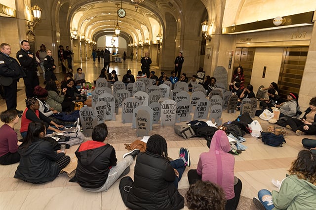 Chicago student organizers maintained a daylong presence at Chicago's City Hall on Wednesday to protest a proposed police academy facility. Students created cardboard headstones in memory of people killed by police as well as community hubs, such as schools and clinics, that have been shuttered under Chicago Mayor Rahm Emanuel. (Photo: Sarah-Ji)