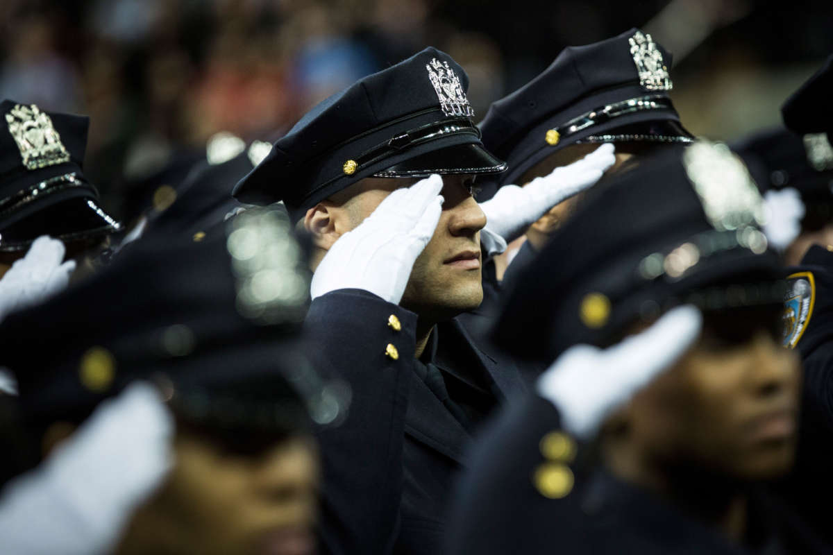 Police officers attend their New York Police Department graduation ceremony at Madison Square Garden on December 29, 2014, in New York City.