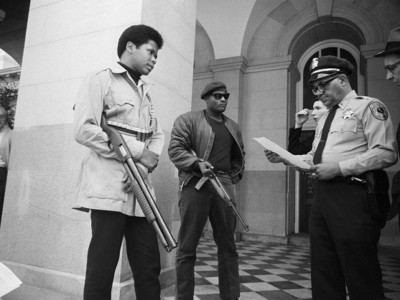 Two members of the Black Panther Party are met on the steps of the State Capitol in Sacramento, May 2, 1967, by Police Lt. Ernest Holloway, who informs them they will be allowed to keep their weapons as long as they cause no trouble and do not disturb the peace. Activist scott crow says the Black Panthers inspired his own theory of liberatory community armed self-defense.