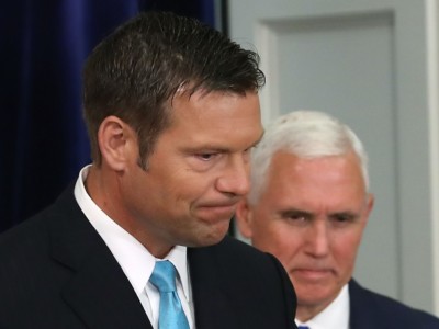 Kansas Secretary of State, Kris Kobach and US Vice President Mike Pence, attend the first meeting of the Presidential Advisory Commission on Election Integrity in the Eisenhower Executive Office Building, on July 19, 2017, in Washington, DC.