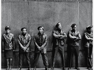 View of a line of Black Panther Party members as they stand outside the New York City courthouse under a portion of an Abraham Lincoln quote which reads "The Ultimate Justice of the People," New York, New York, April 11, 1969.