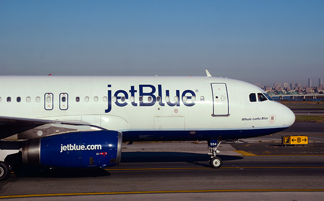 A JetBlue passenger jet (Embraer 190) taxis at LaGuardia Airport in New York, New York.