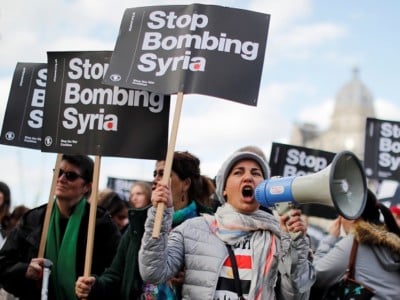 Protesters demonstrate against the UK's military involvement as the US and its allies conduct airstrikes against Syria.