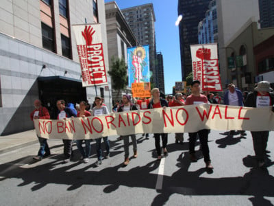 Activists display a sign during the International Workers' Day march on May 1, 2017, in San Francisco, California. (Photo: Peg Hunter)