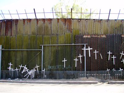 Crosses memoralize those killed at a section of fence along the US / Mexico border.