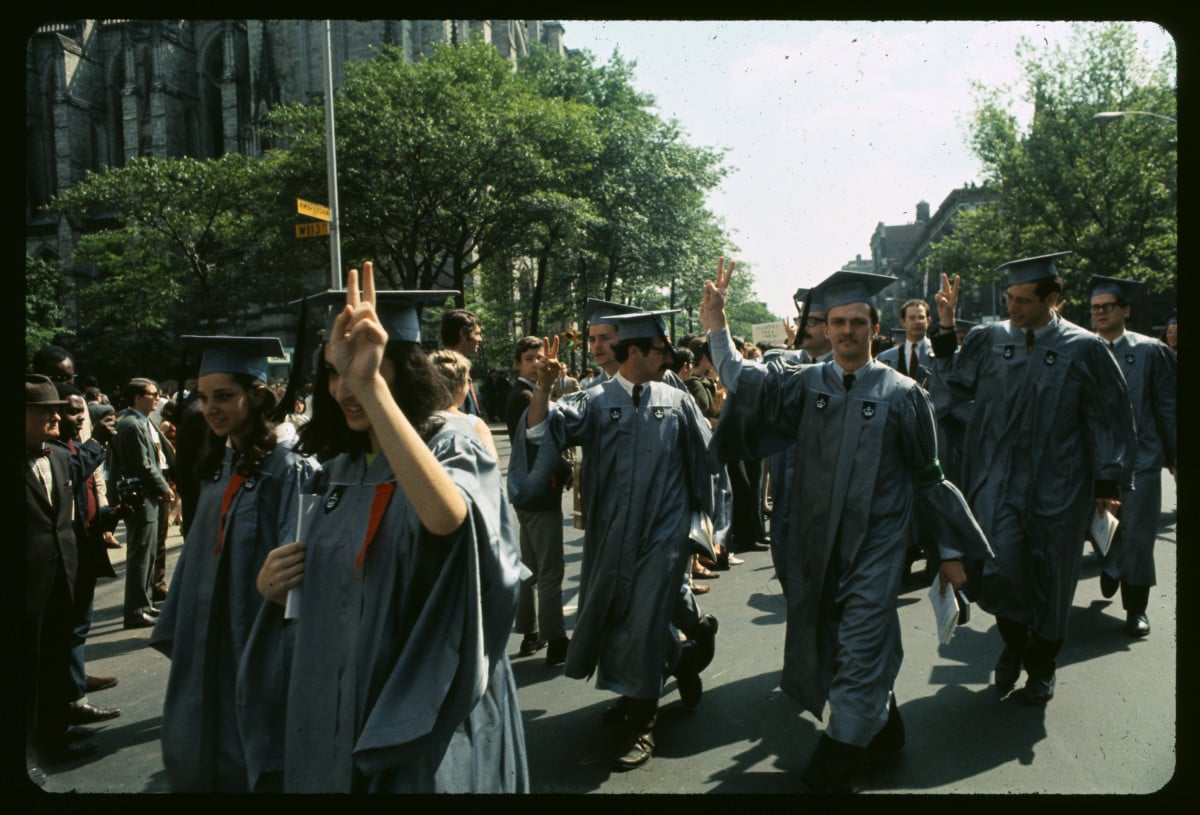Columbia University seniors in cap and gown walk out on their graduation excercises at the Cathedral of St. John the Divine to join some 1,500 student and parent demonstrators on the streets outside on June 4, 1968, in New York City.