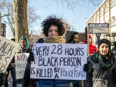 An activist displays a sign during the BYP100 #DecriminalizeBlack protest on December 21, 2014, in Chicago, Illinois.