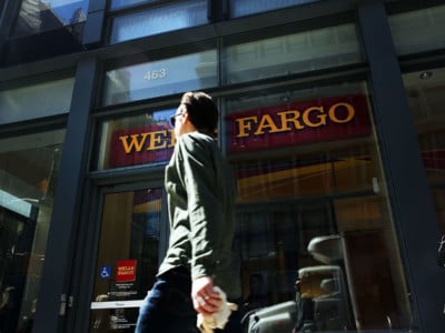 Pedestrians pass a Wells Fargo bank branch in lower Manhattan on April 15, 2016 in New York City. Markets and commercial banks rely on the monetary policies of central banks.