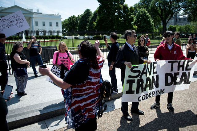Supporters of President Donald Trump argue with people protesting outside the White House as President Trump announces the United State's withdrawal from the Iran nuclear deal, May 8, 2018 in Washington, DC.