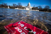 A campaign sign for President Donald Trump lies beneath water in the Capitol Reflecting Pool on Capitol Hill on January 9, 2021, in Washington, D.C.