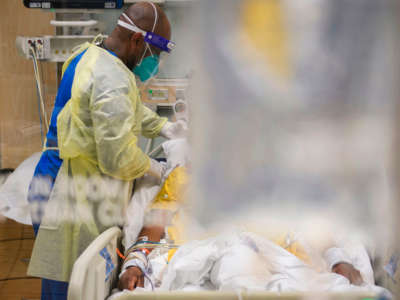 Nurses wearing personal protective equipment attend to patients in a COVID-19 intensive care unit at Martin Luther King Jr. Community Hospital on January 6, 2021, in Los Angeles, California.