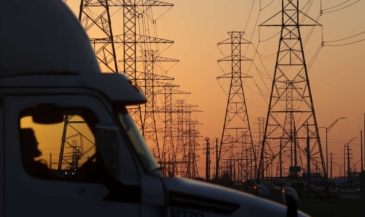 A truck passes a row of high voltage transmission towers on February 21, 2021, in Houston, Texas.