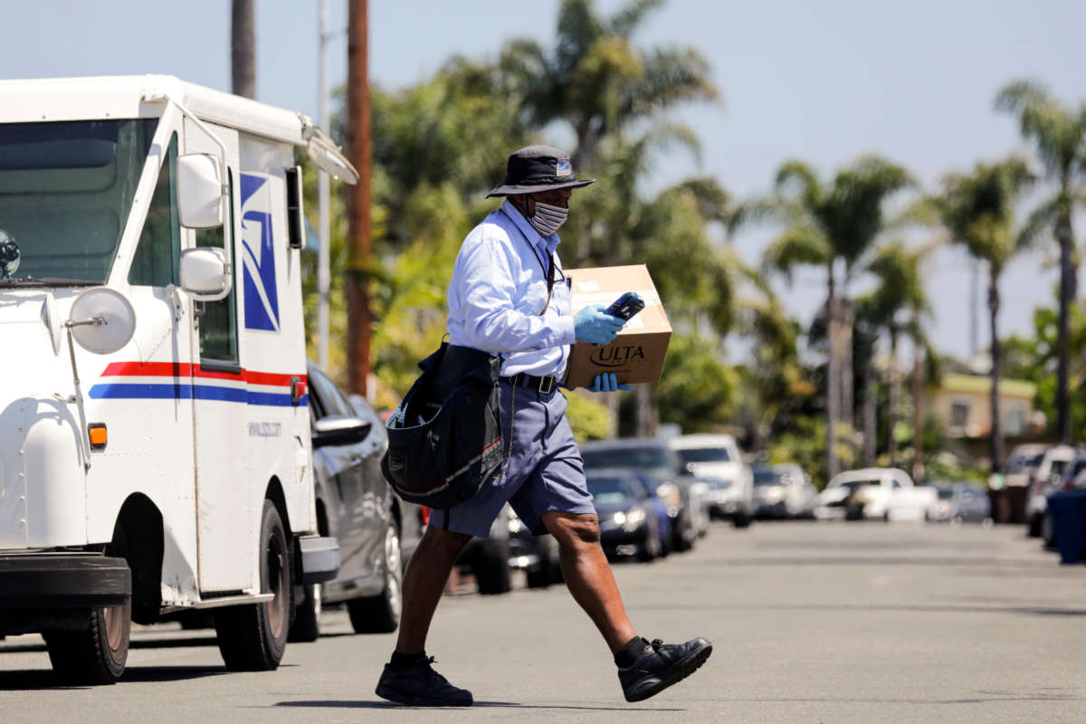 Mailman James Daniels delivers mail on his route on May 15, 2020, in San Clemente, California.