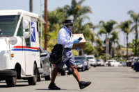 Mailman James Daniels delivers mail on his route on May 15, 2020, in San Clemente, California.