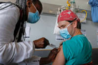 A healthcare worker receives a dose of the Johnson & Johnson vaccine against the COVID-19 coronavirus as South Africa proceeds with its inoculation campaign at the Steve Biko Academic Hospital in Pretoria on February 17, 2021.