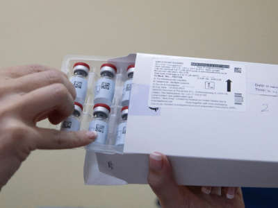 A healthcare worker holds vials containing doses of the Johnson & Johnson vaccine against the COVID-19 coronavirus at the Klerksdorp Hospital on February 18, 2021.