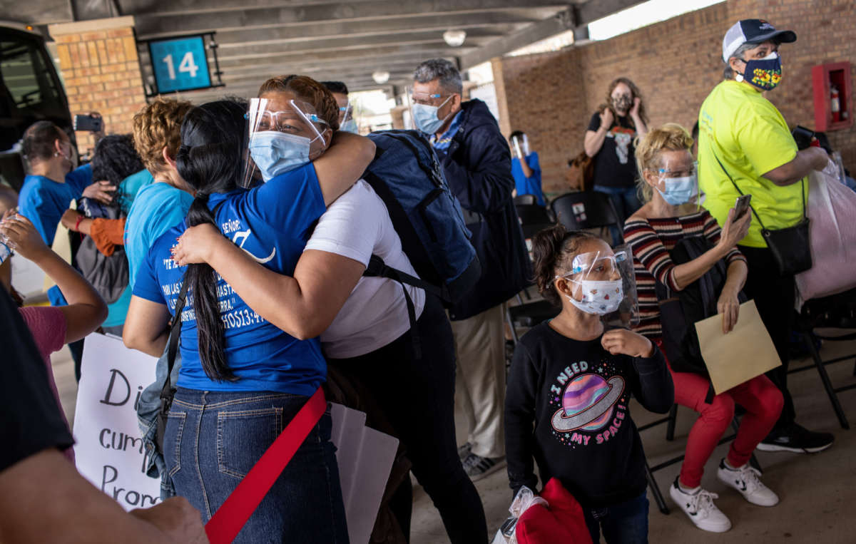 An asylum seeker embraces an immigration volunteer upon her arrival to the United States on February 26, 2021, in Brownsville, Texas.